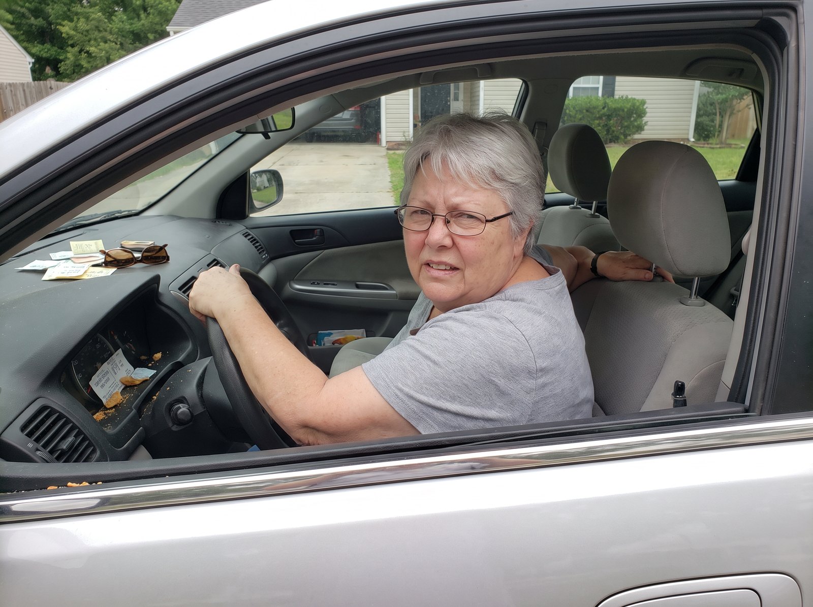 Barbara twisting in her car seat to reverse because she cannot turn her neck