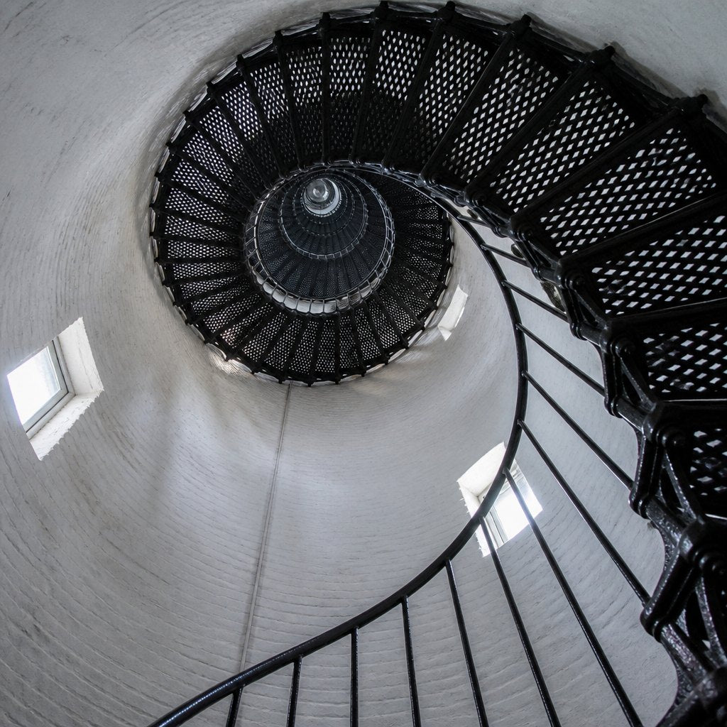 A cast-iron spiral staircase inside a lighthouse tower